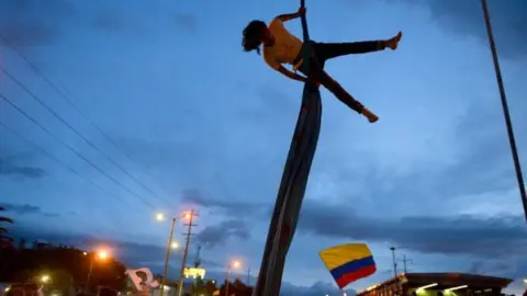 AFP An artist performs during a protest against the government of Colombian President Ivan Duque in Bogota on 27 November, 2019