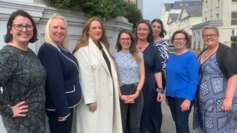 BBC L-R Sarah Maltby, Julie Edge, Claire Christian, Joney Faragher, Daphne Caine, Kate Lord-Brennan, Jane Poole-Wilson, Clare Barber