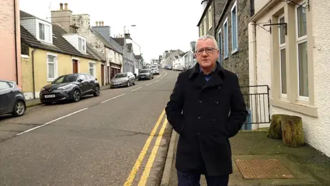 BBC / Jonathan Sumberg Allan Little in the village of Glenluce where he grew up