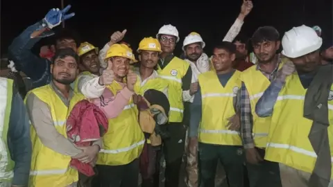 EPA A handout photo made available by Uttarakhand"s Department of Information and Public Relation (DIPR) shows workers following their rescue from inside the under-construction Silkyara tunnel on the Brahmakal Yamunotri National Highway in Uttarkashi, India, 28 November 2023.