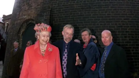 Reuters/Alamy Stock Photo The Queen with a group of men next to a kiln