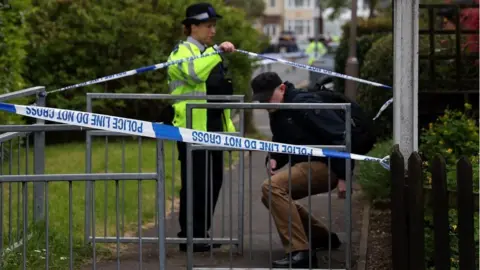 Man being let through cordon by police officer