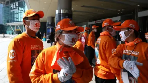 Getty Images Campaigners with gloves and face masks