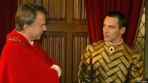 Getty Images Jonathan in Tudor garb as Henry VIII with co-star Sam Neil
