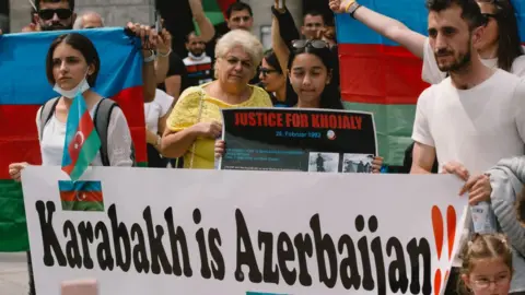 Getty Images Protesters in Germany holding a sign saying Karabakh is Azerbaijan