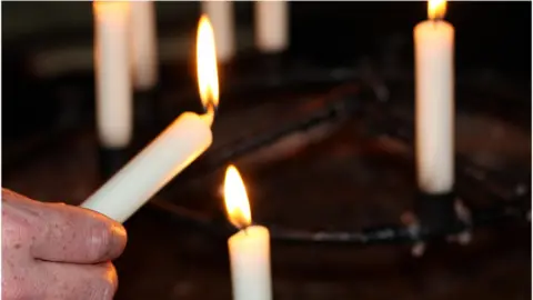 BBC Lit candles in church