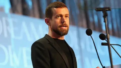 Getty Images Man standing in front of microphone