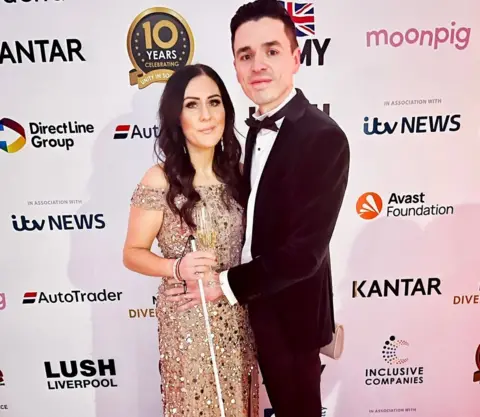 Katie Berill Katie with her cane and husband