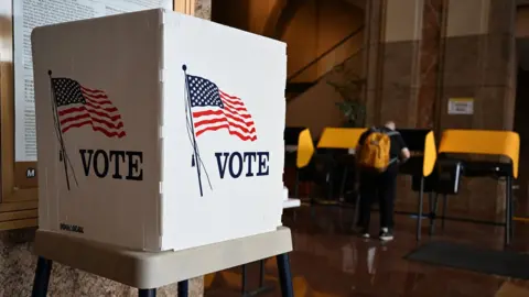 Getty Images A voter prepares their ballot at a polling station during early voting ahead of the US midterm elections in Los Angeles, California, on November 1, 2022