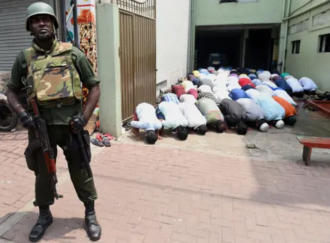 Getty Images A soldier guards a mosque in Colombo in 2018, at the time of the Kandy riots