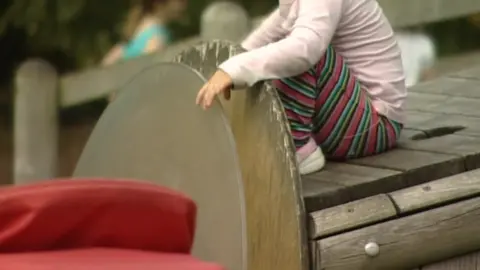 BBC Child sat on bench