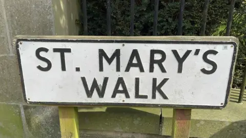 BBC / Naj Modak Old street sign on St Mary's Walk