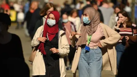 Getty Images Women wearing masks in Newcastle