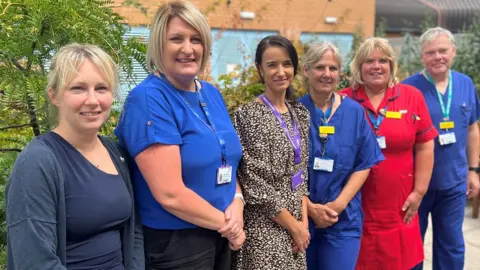 Somerset NHS Foundation Trust Six women in scrubs from the team who work on the service