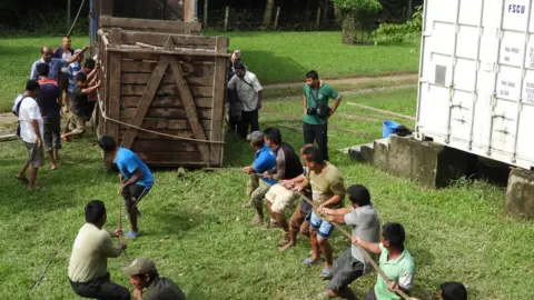 Ishwor Joshi Teams help unloads the returning rhino