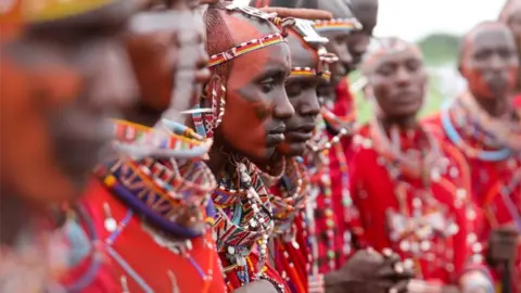 Getty Images Maasai men take part in a sporting event in Kimana, near Kenya's border with Tanzania.