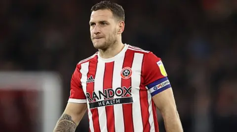 Sheffield United's Billy Sharp was assaulted by a fan during a pitch invasion