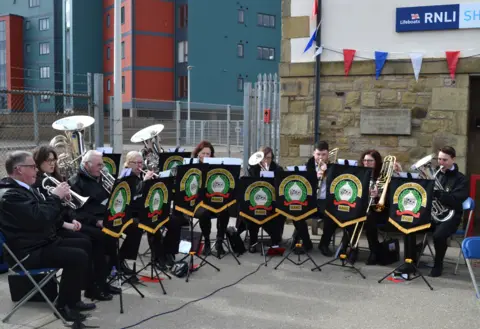 James Scott A band plays instruments 