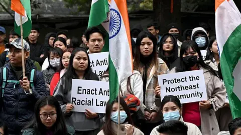 Getty Images Student groups gather in Delhi on 31 December with placards seeking protection for people belonging to northeastern states and demanding an anti-racial law