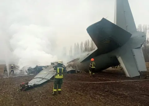 Ukrainian State Emergency Service / Reuters Rescuers work at the crash site of a Ukrainian Armed Forces' Antonov aircraft, shot down in the Kyiv region, Ukraine