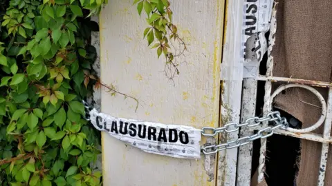 A photo of a house in Guadalajara which was cordoned of by officials after bodies were found inside