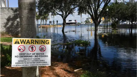 Getty Images A warning sign near floodwaters