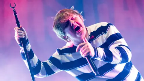 Getty Images Lewis Capaldi singing live on stage