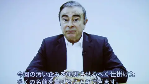 Reuters Carlos Ghosn delivering a video statement with Japanese captions in April 2019