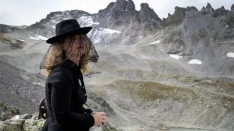 Getty Images A woman takes part in a ceremony to mark the "death" of the Pizol glacier