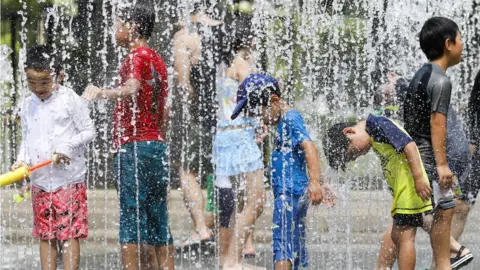 EPA Children play in the water jets at a park near Nerima in Tokyo, Japan, 23 July 2018