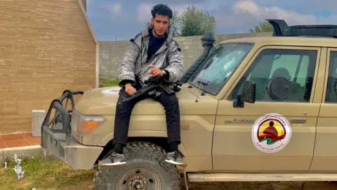 Facebook Elyas Elmehdi, with gun