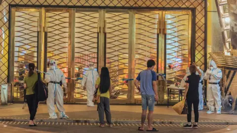 Getty Images Macau's Grand Lisboa hotel under lockdown after Covid-19 cases were found there.