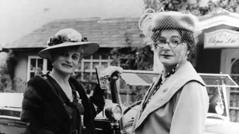 BBC Picture shows Patrick Fyffe as Dame Hilda Bracket and George Logan as Dr Evadne Hinge.