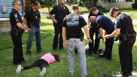 Getty Images Woman who overdosed on heroin lying on the grass