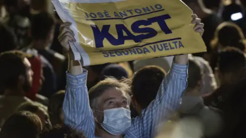 Getty Images A supporter of candidate of the Republic party Jose Antonio Kast celebrates at the end of the Presidential Elections on November 21, 2021 in Santiago, Chile.