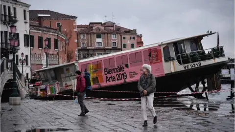 AFP A taxi boat is stranded on the streets of Venice