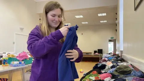 BBC Volunteer Rebecca Gilbert prepares for the latest village hall swap shop.