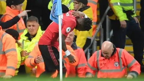 Getty Images Fred seen to be hit by an object