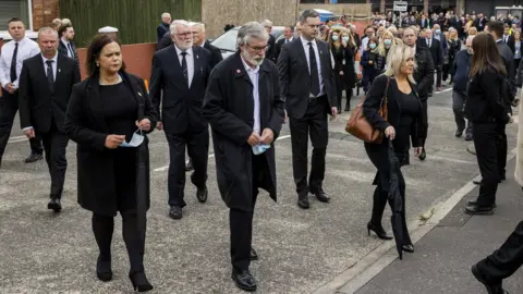 PA Media Mary Lou McDonald, Gerry Adams and Michelle O'Neill at the funeral of Bobby Storey