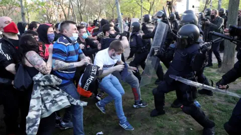 EPA Spanish National Police members clash with protesters during Vox's regional election kick-off campaign rally in Vallecas, Madrid, Spain, 07 April 2021