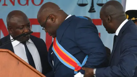 Reuters Felix Tshisekedi being helped after feeling faint
