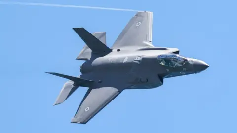 Getty Images An Israeli Air Force F-35 Lightning II fighter aircraft flies over during an air show in Tel Aviv on 26 April 2023