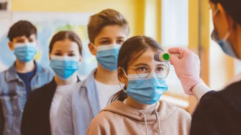 Getty Images Children getting temperature testing for coronavirus