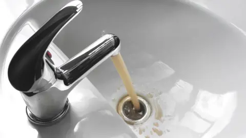 Getty Images Brown water coming out of a tap