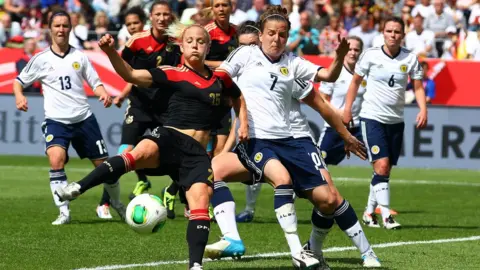 Getty Images Scotland's Hayley Lauder challenges a German player