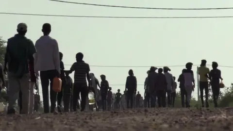 Reuters People silhouetted walking away from the camera