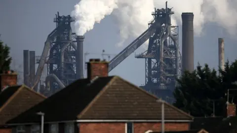  LINDSEY PARNABY/AFP via Getty Images Vapour rising from chimneys at the Scunthorpe steelworks