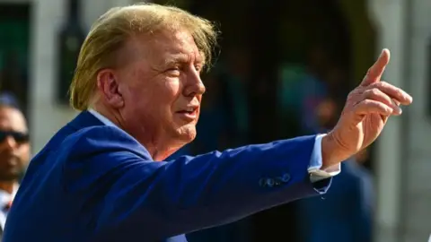 Getty Images Donald Trump points his finger up
