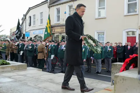 PA Media Leo Varadkar lays a wreath at the war memorial in Enniskillen