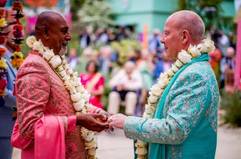 REX/Shutterstock Manoj Malde, married his partner Clive Gillmor, in the RHS and Eastern Eye Garden of Unity,.